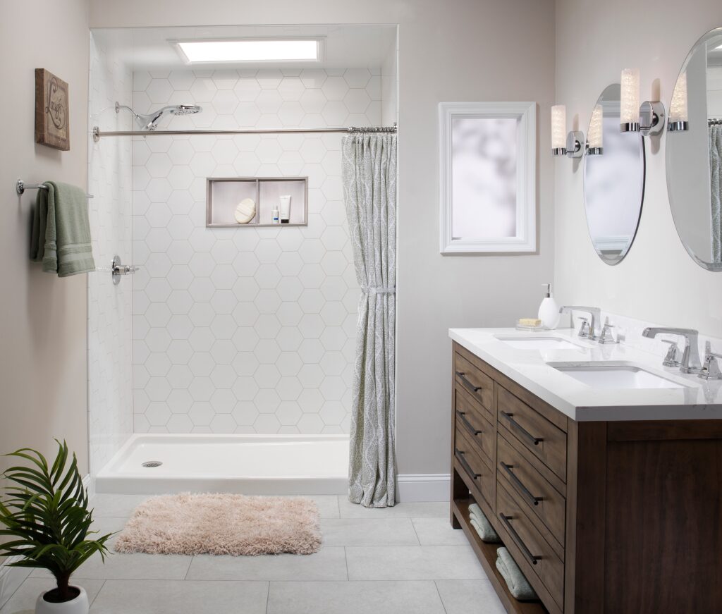 Modern bathroom with a shower, frosted curtain, and a double-sink wood vanity with oval mirrors and wall sconces on the right.