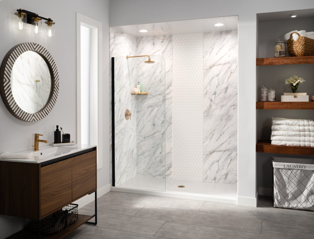 Modern bathroom with wooden vanity, round striped mirror, and gold faucet beside a white sink.